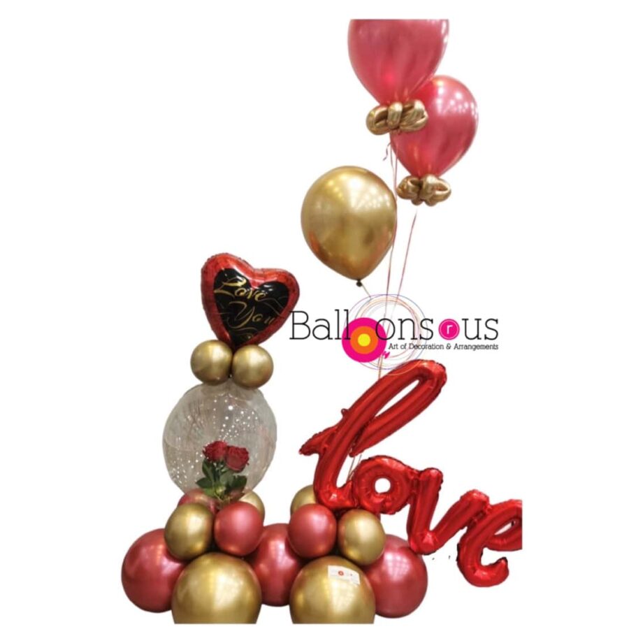 Arrangement of love with artificial flowers inside clear balloon